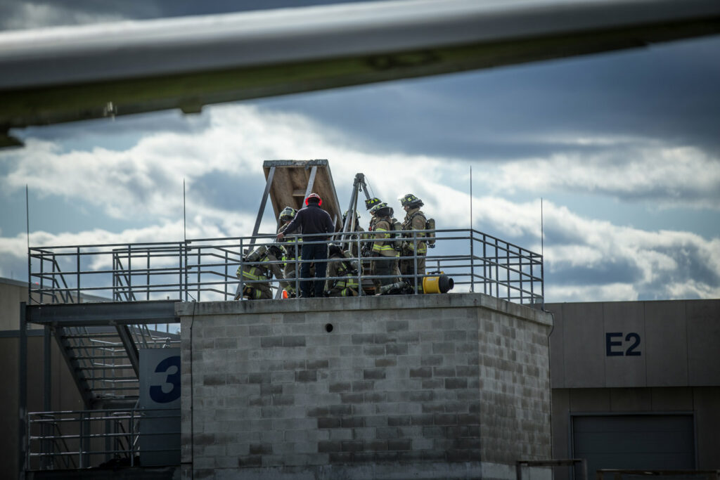 Festi firefighters on top of roof