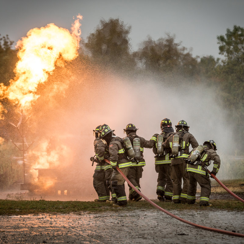 Firefighters Fighting Fire With Portable Fire Extinguishers