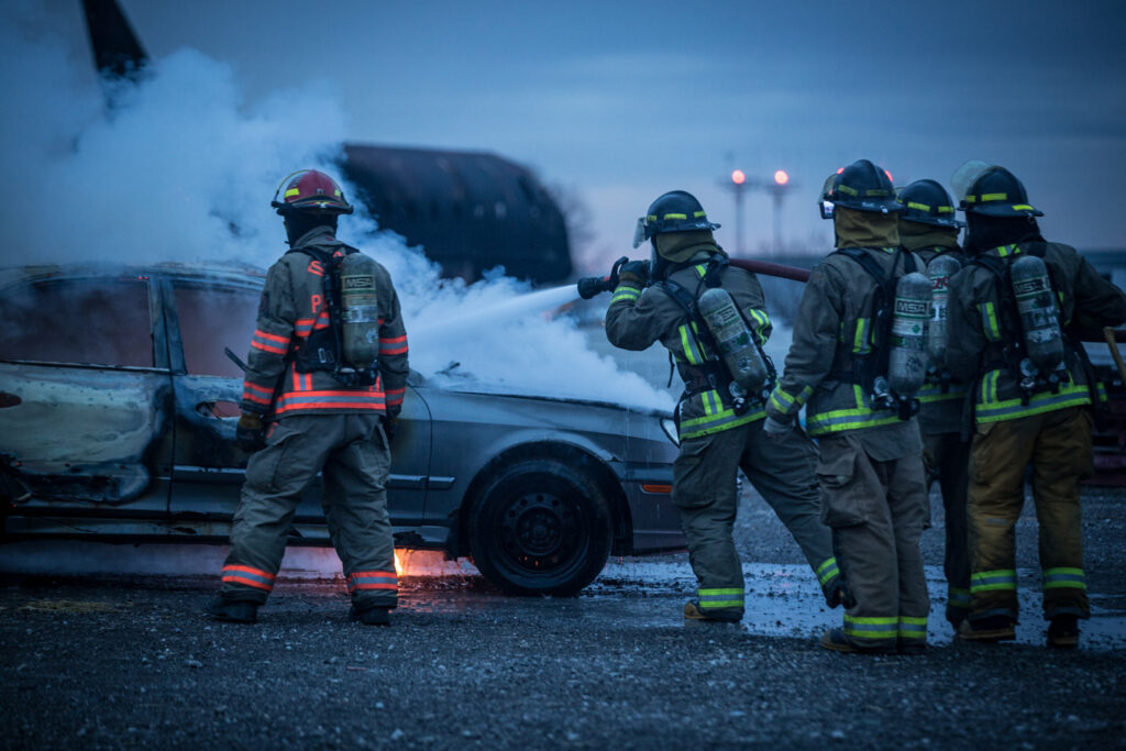 Firefighters putting out car fire