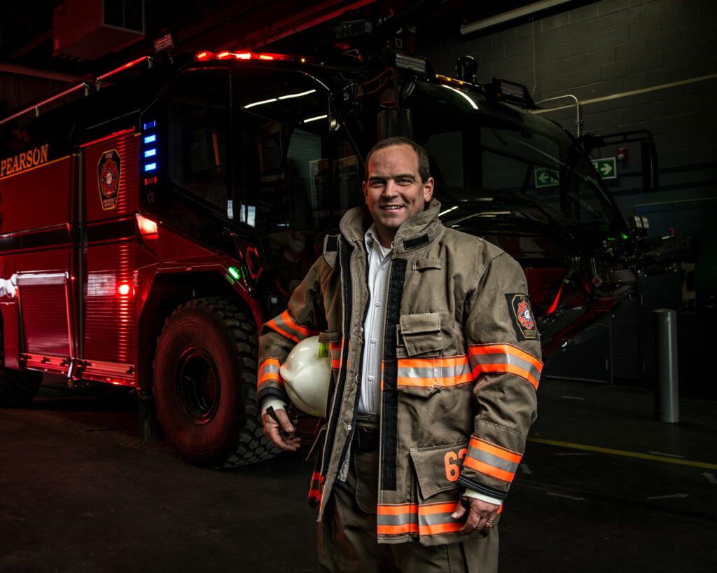 Festi Firefighter In Front Of Fire Truck