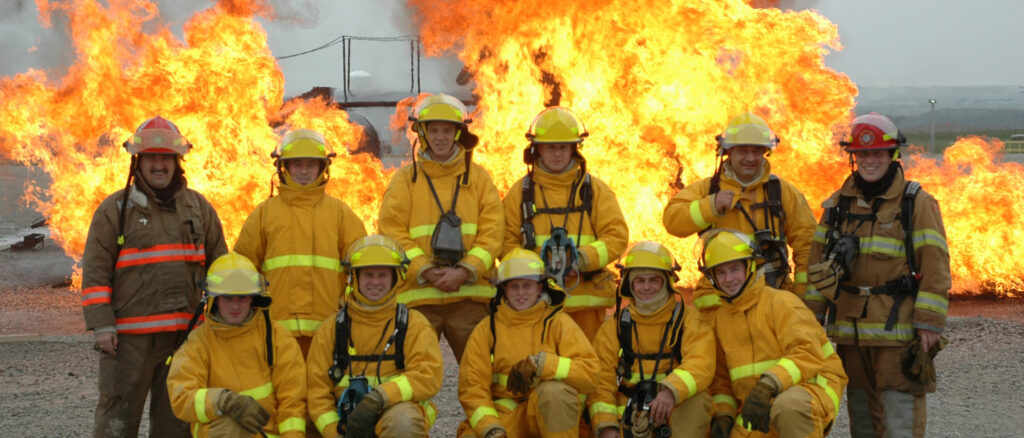 Team of firefighters in front of fire